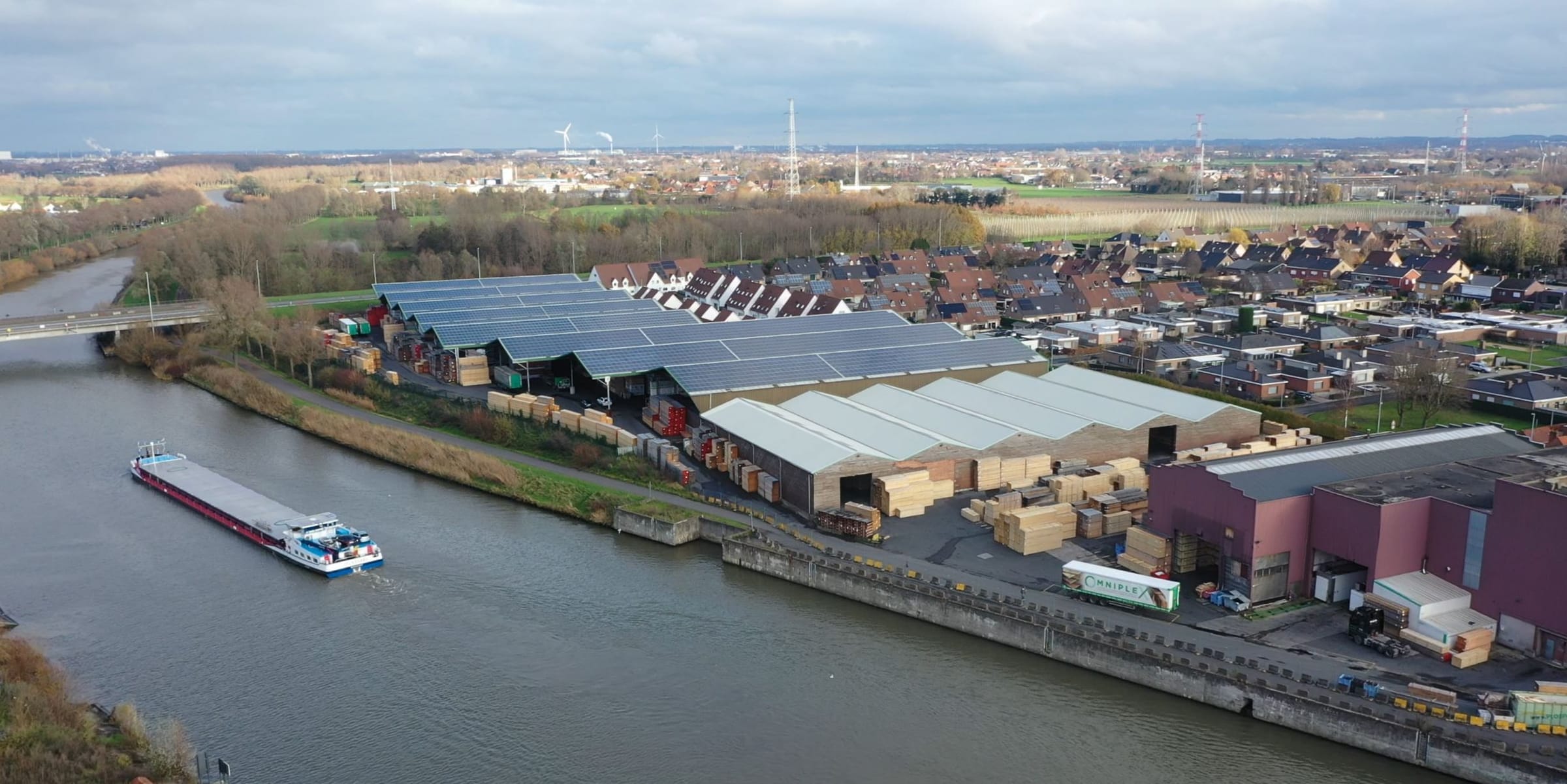 Aerial view of the Leieboorden depot with a barge on the river Lys
