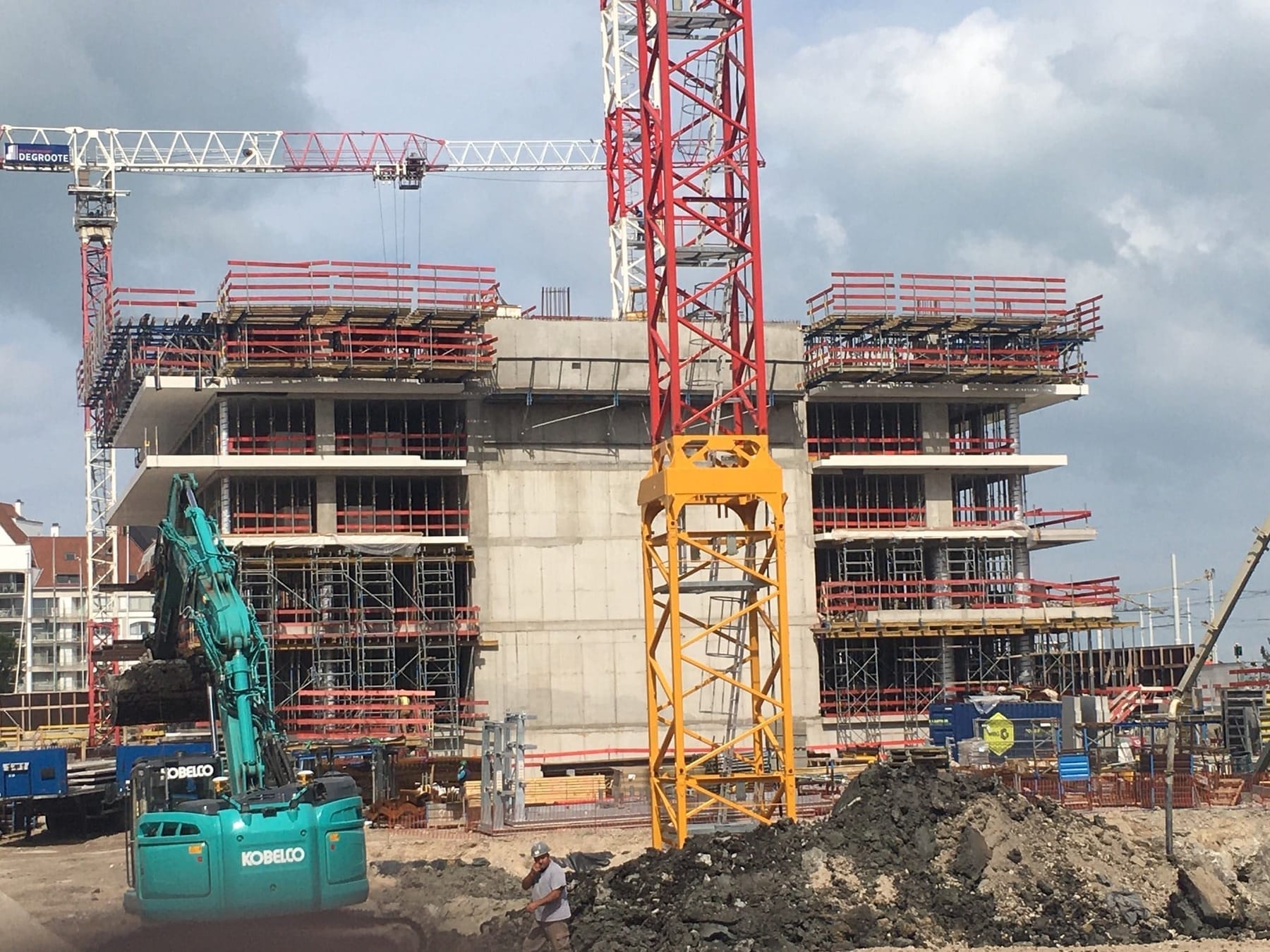 Construction site with concrete formwork and tower cranes