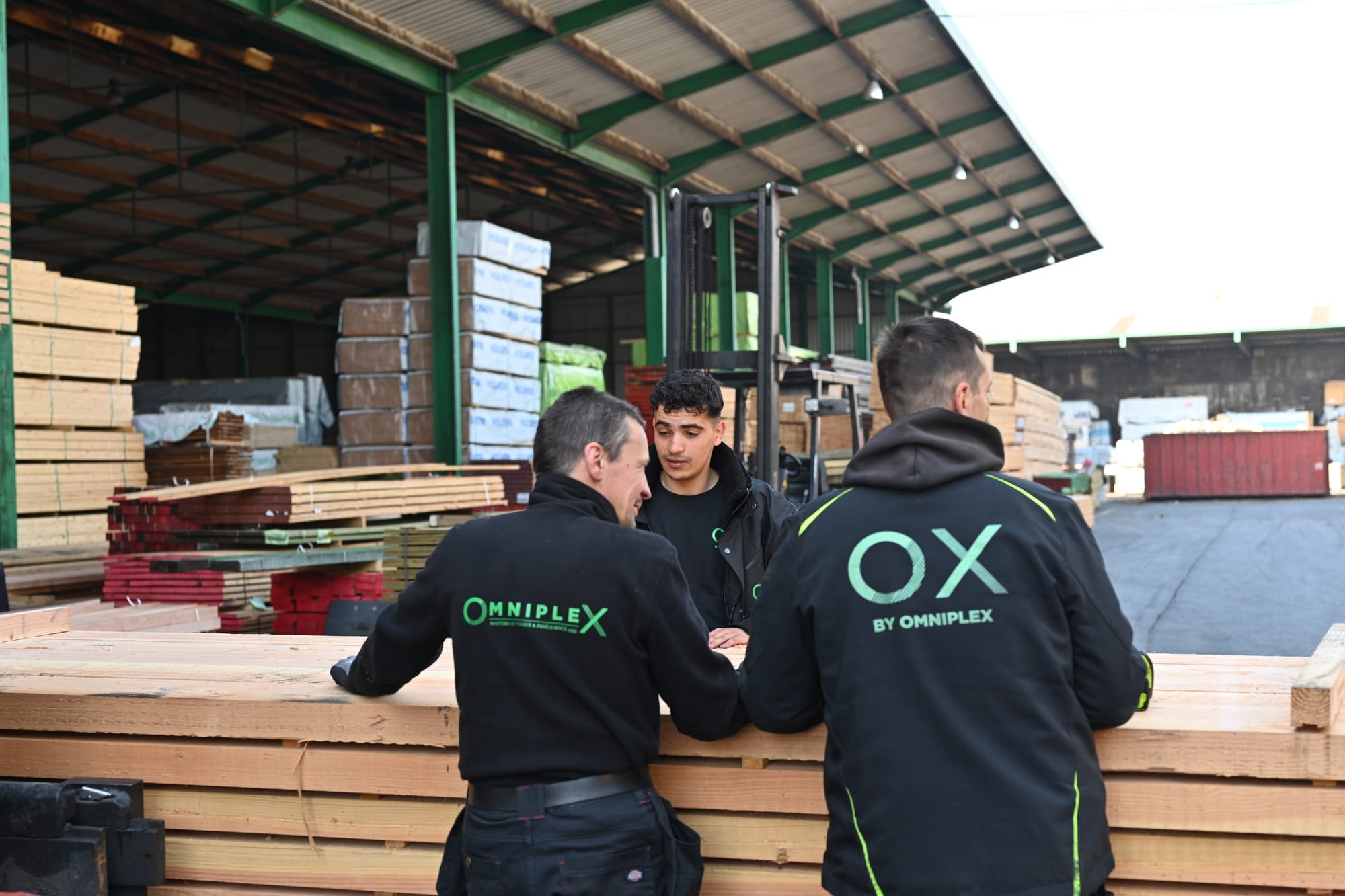 Omniplex staff with packs of timber in the warehouse